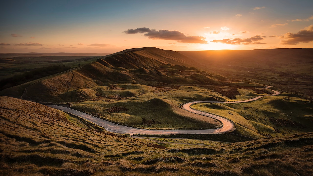 Sunset over a winding countryside road in Castleton